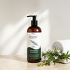 Senerita+ Rosemary Shampoo 400ml lifestyle on cream marble with rosemary sprigs and white flowers