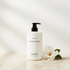 Byredo Mojave Ghost Conditioner 450ml lifestyle on cream marble with magnolia