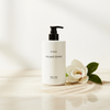 Byredo Mojave Ghost Body Wash 450ml lifestyle on cream marble with magnolia