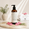 Le Labo Rose 31 Body Lotion 480ml lifestyle on cream marble with rose petals